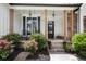 Cozy front porch with rocking chairs and stone steps, framed by lush landscaping and classic architectural details at 244 Cedar Ridge Way, Dallas, GA 30157