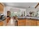 Kitchen with wooden cabinets and granite countertops next to dining area at 244 Cedar Ridge Way, Dallas, GA 30157