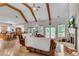Spacious living room with hardwood floors, a stone fireplace, and large windows offering lots of natural light at 244 Cedar Ridge Way, Dallas, GA 30157