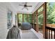 Relaxing screened porch with wood flooring, fan, and views of the wooded backyard at 244 Cedar Ridge Way, Dallas, GA 30157