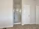 Modern bathroom featuring a glass-enclosed shower, tile flooring, and a white door at 3110 Cambrian Ter, Austell, GA 30106