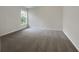 A well-lit bedroom with gray carpet, neutral walls, and a large window at 3110 Cambrian Ter, Austell, GA 30106