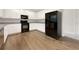 Modern kitchen featuring white cabinets, stainless steel appliances, and hardwood floors at 3110 Cambrian Ter, Austell, GA 30106