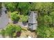 Aerial view of home showcasing the roofline, yard, and surrounding greenery at 1550 Pine Creek Way, Woodstock, GA 30188