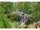 Aerial view of home with an attached garage surrounded by mature trees at 1550 Pine Creek Way, Woodstock, GA 30188