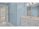 A bright bathroom featuring a white vanity, decorative mirror, and access to other rooms at 1550 Pine Creek Way, Woodstock, GA 30188