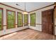 Bright breakfast nook with wood floors and lots of natural light from three windows at 1550 Pine Creek Way, Woodstock, GA 30188