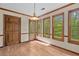 Bright breakfast nook with wood floors and lots of natural light from three windows at 1550 Pine Creek Way, Woodstock, GA 30188