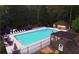 Aerial view of a sparkling community pool with lounge chairs and umbrellas at 1550 Pine Creek Way, Woodstock, GA 30188