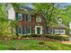 Lovely brick home with blue shutters, well-maintained landscaping, and a welcoming front entrance at 1550 Pine Creek Way, Woodstock, GA 30188