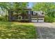 Beautiful two-story brick home with a well-manicured lawn and a two-car garage at 1550 Pine Creek Way, Woodstock, GA 30188