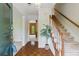 Welcoming foyer featuring hardwood floors, a staircase, and a view into adjacent rooms at 1550 Pine Creek Way, Woodstock, GA 30188
