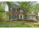 Well-manicured front yard and traditional brick home with lovely landscaping at 1550 Pine Creek Way, Woodstock, GA 30188