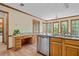 Traditional kitchen featuring wood cabinets, granite counters, stainless dishwasher and workstation at 1550 Pine Creek Way, Woodstock, GA 30188