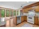 Traditional kitchen featuring wood cabinets, granite counters and stainless dishwasher at 1550 Pine Creek Way, Woodstock, GA 30188