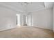 Spacious main bedroom with neutral carpet, and two entry doors at 1550 Pine Creek Way, Woodstock, GA 30188