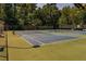 Well-maintained community tennis courts with benches and a surrounding fence at 1550 Pine Creek Way, Woodstock, GA 30188