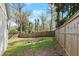 Spacious backyard with mature trees, a wooden fence, and plenty of room for outdoor activities at 2870 Ridgemore Nw Rd, Atlanta, GA 30318