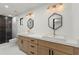 Modern bathroom with double vanity, dual mirrors and black tile shower at 2870 Ridgemore Nw Rd, Atlanta, GA 30318