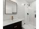 Stylish bathroom with white walls, a sleek black vanity, and a glass-enclosed shower, offering a modern and clean aesthetic at 2870 Ridgemore Nw Rd, Atlanta, GA 30318