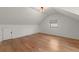 Bright bedroom with hardwood floors, simple decor, and a large window offering ample light at 2870 Ridgemore Nw Rd, Atlanta, GA 30318