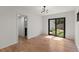 Well-lit bedroom with hardwood floors, neutral walls, and backyard access at 2870 Ridgemore Nw Rd, Atlanta, GA 30318