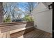Wooden deck with built-in seating, offering a relaxing outdoor space with a view of the surrounding greenery and blue sky at 2870 Ridgemore Nw Rd, Atlanta, GA 30318