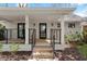 Inviting white brick home featuring a covered front porch with modern black railings and front door at 2870 Ridgemore Nw Rd, Atlanta, GA 30318
