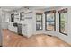 Light, modern kitchen with open shelving, stainless appliances, and adjacent breakfast nook at 2870 Ridgemore Nw Rd, Atlanta, GA 30318