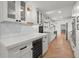 Modern kitchen with white cabinets, quartz countertops, and a built-in wine cooler, designed for both style and functionality at 2870 Ridgemore Nw Rd, Atlanta, GA 30318