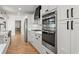 Gourmet kitchen featuring stainless steel appliances, white cabinets, and sleek countertops, perfect for culinary enthusiasts at 2870 Ridgemore Nw Rd, Atlanta, GA 30318