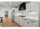 Modern kitchen featuring white cabinets, stainless steel appliances and chevron wood flooring at 2870 Ridgemore Nw Rd, Atlanta, GA 30318