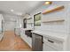 Bright kitchen boasts white cabinets, stainless appliances, and open shelving at 2870 Ridgemore Nw Rd, Atlanta, GA 30318