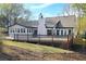 Rear exterior view of the home highlighting the large deck and freshly landscaped yard at 1960 Calvin Dr, Duluth, GA 30097