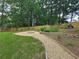 Serene backyard featuring a custom fire pit, stone accents, and lush greenery, offering a relaxing outdoor experience at 1960 Calvin Dr, Duluth, GA 30097