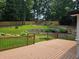 Charming backyard with a wooden deck that overlooks a professionally landscaped yard with flower beds and mature trees at 1960 Calvin Dr, Duluth, GA 30097