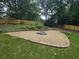 Backyard fire pit area with stone border and gravel surround, perfect for enjoying outdoor evenings at 1960 Calvin Dr, Duluth, GA 30097
