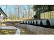 Professionally landscaped backyard with tiered retaining walls and fresh mulch beds featuring planted trees at 1960 Calvin Dr, Duluth, GA 30097