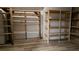 Basement with wood plank flooring and a partially finished wood shelving system along the walls at 1960 Calvin Dr, Duluth, GA 30097