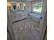Bright bathroom featuring a soaking tub under a large window and double sink vanity at 1960 Calvin Dr, Duluth, GA 30097