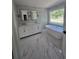 Bright bathroom featuring a soaking tub under a large window and double sink vanity at 1960 Calvin Dr, Duluth, GA 30097