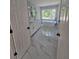 Bright bathroom featuring a soaking tub under a large window and double sink vanity at 1960 Calvin Dr, Duluth, GA 30097