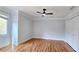 Bright bedroom with hardwood floors, a modern ceiling fan, and a large window offering natural light at 1960 Calvin Dr, Duluth, GA 30097
