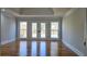 Spacious bedroom with hardwood floors and french doors leading to private balcony at 1960 Calvin Dr, Duluth, GA 30097