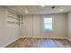 Bright bedroom featuring wood flooring, recessed lighting, a built-in bookshelf, and a window at 1960 Calvin Dr, Duluth, GA 30097