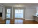 Bright dining area featuring hardwood floors, a stylish light fixture, and a view of the outdoors at 1960 Calvin Dr, Duluth, GA 30097