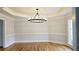 Formal dining room with hardwood floors, modern chandelier, and sophisticated trim details at 1960 Calvin Dr, Duluth, GA 30097