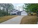 Attractive home featuring well-maintained lawn, long driveway, and a welcoming facade at 1960 Calvin Dr, Duluth, GA 30097