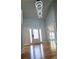 Bright and airy entryway with hardwood floors and modern lighting fixtures at 1960 Calvin Dr, Duluth, GA 30097