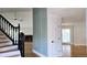 Inviting foyer featuring hardwood floors, elegant staircase, and wainscoting, filled with natural light at 1960 Calvin Dr, Duluth, GA 30097